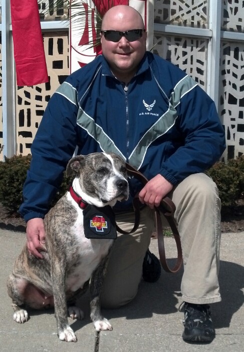 Photo of gray and white dog named Alex with her owner, Chip Ingersoll